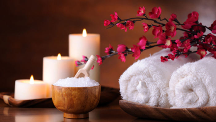 spa products with stones towels flasks and oil